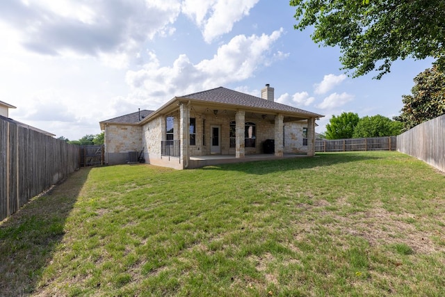 2129 Aaron Ross Way, Round Rock, TX 78665 - rear view of property with stone siding, a chimney, a patio, and a fenced backyard
