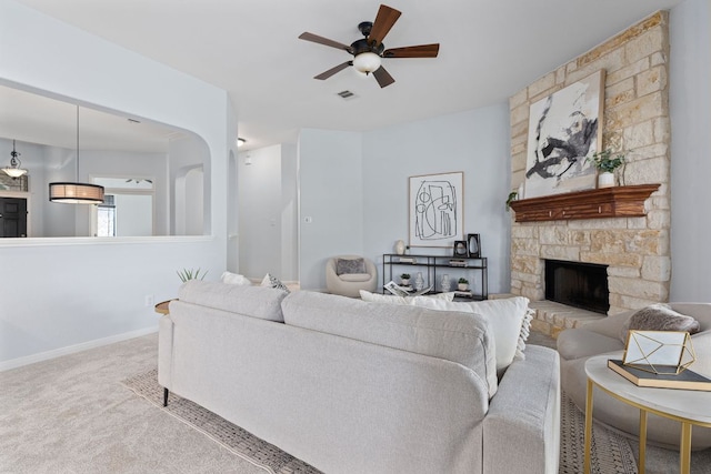 2129 Aaron Ross Way, Round Rock, TX 78665 - living room featuring ceiling fan, carpet floors, and a stone fireplace