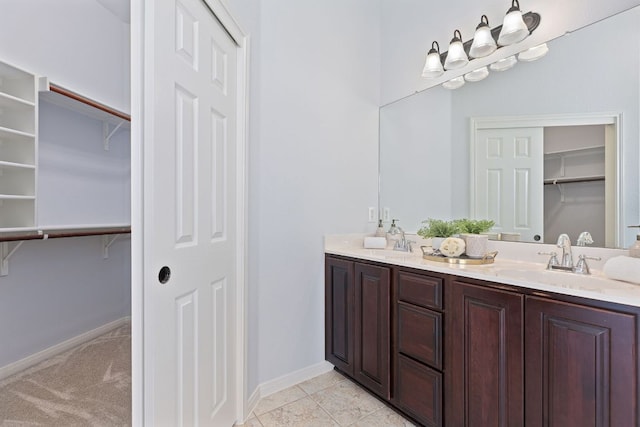 2129 Aaron Ross Way, Round Rock, TX 78665 - full bath with double vanity, a walk in closet, and tile patterned flooring