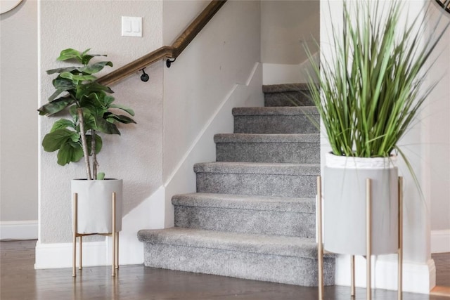 stairs featuring baseboards and wood finished floors