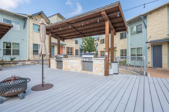 7805 Cooper Ln Unit 103, Austin, TX 78745 - wooden terrace with a fire pit, an outdoor kitchen, and grilling area