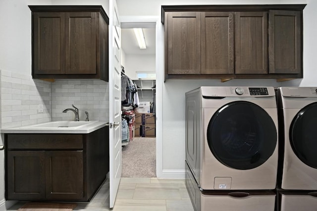 233 Abbeyville Walk, Austin, TX 78738 - laundry room featuring washing machine and dryer, cabinet space, baseboards, and light carpet
