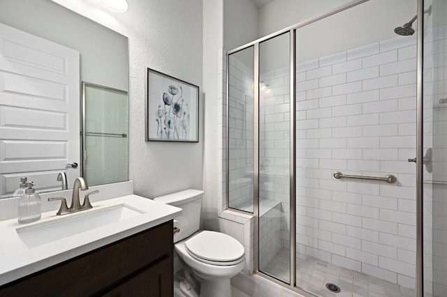 233 Abbeyville Walk, Austin, TX 78738 - full bathroom with vanity, a shower stall, toilet, and a textured wall