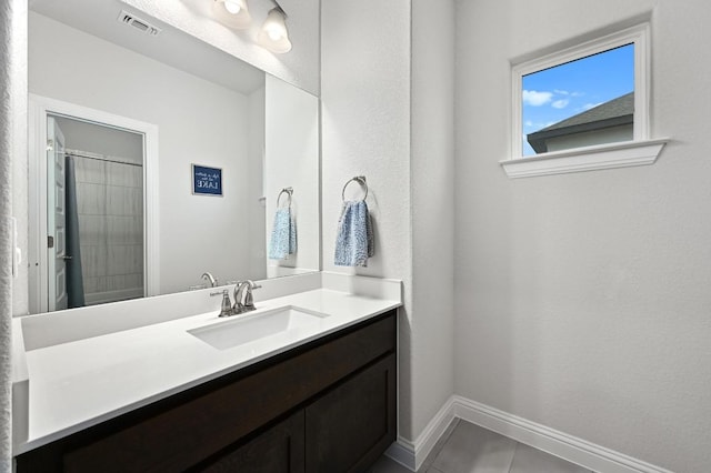 233 Abbeyville Walk, Austin, TX 78738 - bathroom with vanity, baseboards, and a shower