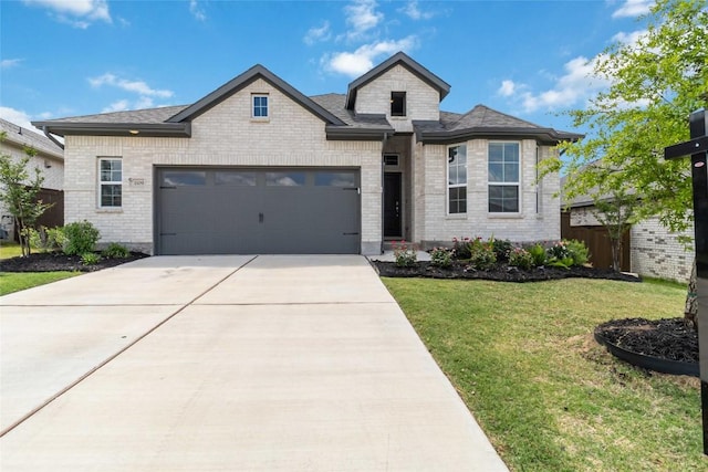 1109 Sweetspire St, Leander, TX 78641 - french country home featuring an attached garage, concrete driveway, and brick siding