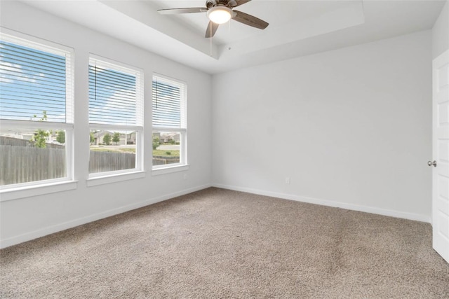 1109 Sweetspire St, Leander, TX 78641 - spare room featuring a raised ceiling, carpet flooring, ceiling fan, and baseboards