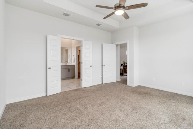 1109 Sweetspire St, Leander, TX 78641 - unfurnished bedroom featuring light carpet, baseboards, ensuite bath, and ceiling fan