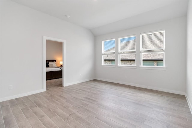 1109 Sweetspire St, Leander, TX 78641 - spare room featuring light wood-style flooring, baseboards, and vaulted ceiling
