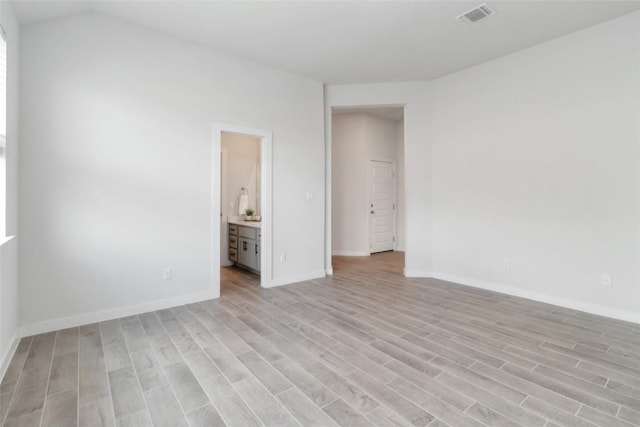 1109 Sweetspire St, Leander, TX 78641 - unfurnished bedroom with light wood-type flooring, baseboards, and ensuite bathroom