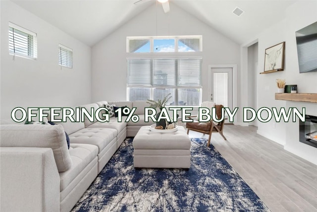 1109 Sweetspire St, Leander, TX 78641 - living room with wood finished floors, ceiling fan, and high vaulted ceiling