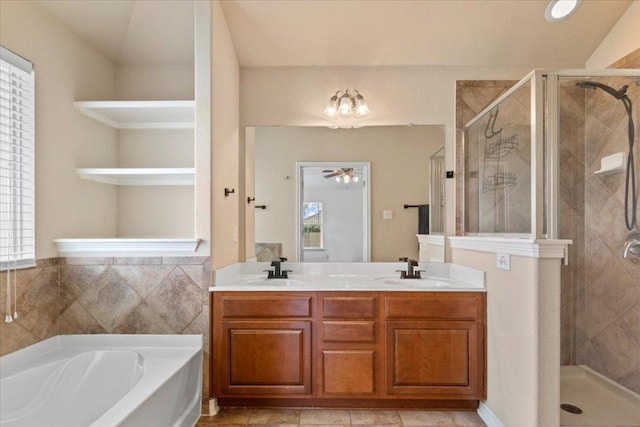 full bath with a bath, double vanity, a sink, and a shower stall