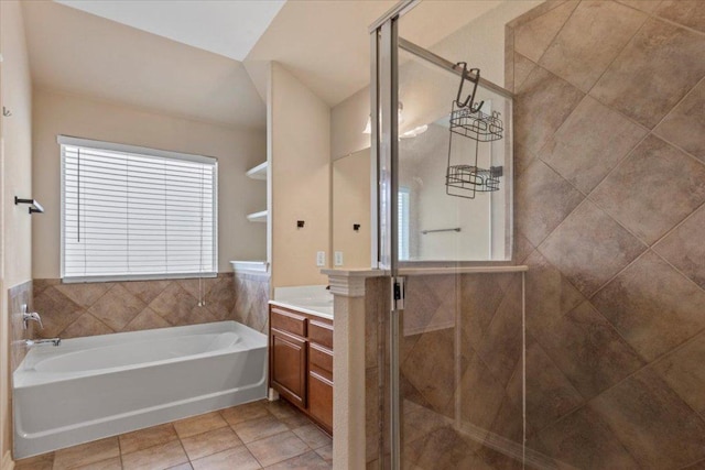 bathroom with a bath, tile patterned flooring, a shower stall, and vanity