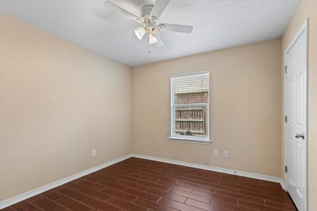spare room with baseboards, wood tiled floor, and ceiling fan