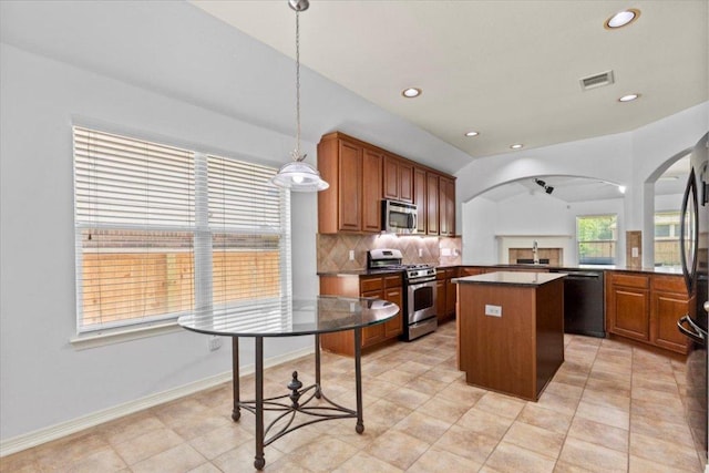 kitchen with a sink, black appliances, backsplash, a kitchen island, and dark countertops