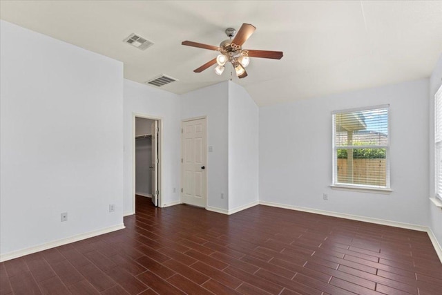 spare room featuring visible vents, ceiling fan, and wood finished floors