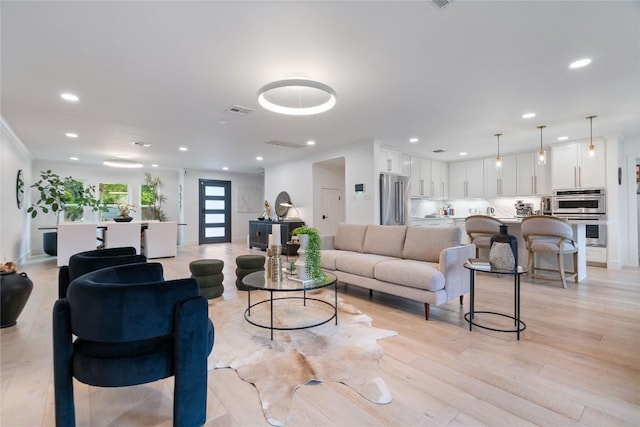 living room featuring recessed lighting, visible vents, and light wood-style flooring