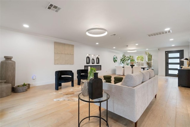 living room with light wood finished floors, recessed lighting, and visible vents