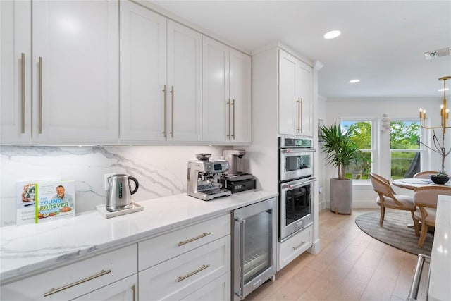 kitchen featuring white cabinets, recessed lighting, tasteful backsplash, wine cooler, and visible vents