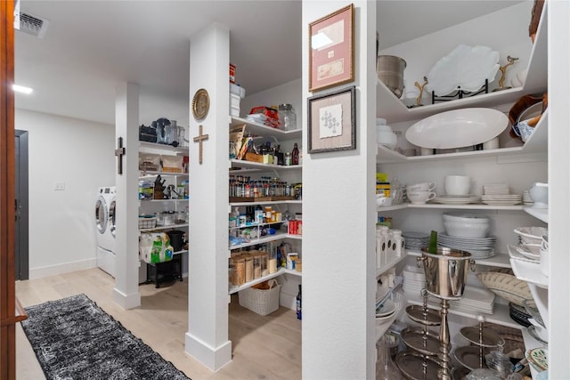 pantry with washer and dryer and visible vents