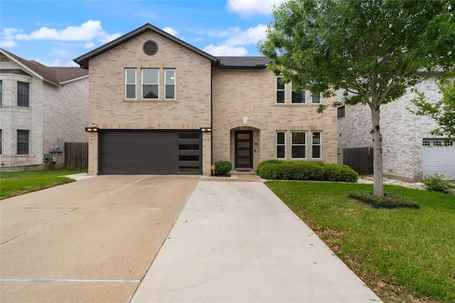 11009 Midbury Ct, Austin, TX 78748 - view of front facade featuring fence, brick siding, driveway, a garage, and a front yard
