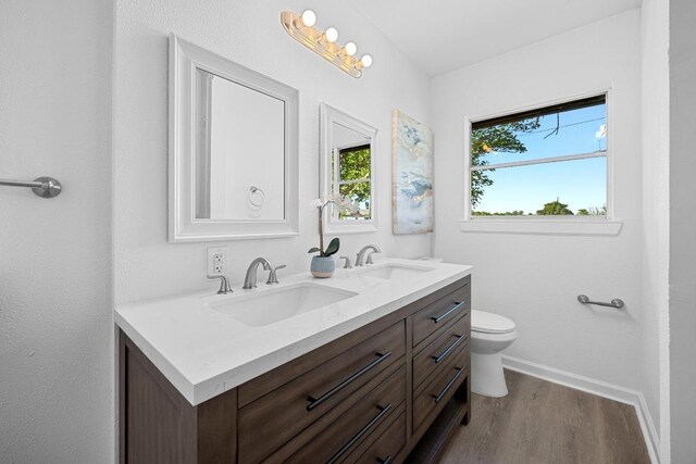 2111 Mardean Ln, Temple, TX 76501 - full bathroom with baseboards, wood finished floors, double vanity, and a sink