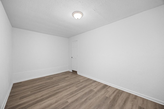 2111 Mardean Ln, Temple, TX 76501 - unfurnished room with a textured ceiling, wood finished floors, and baseboards