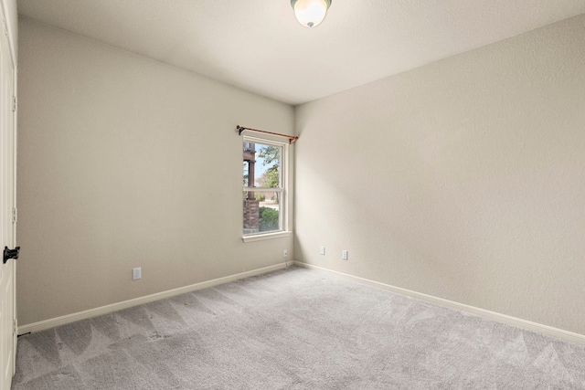 unfurnished room featuring carpet flooring and baseboards