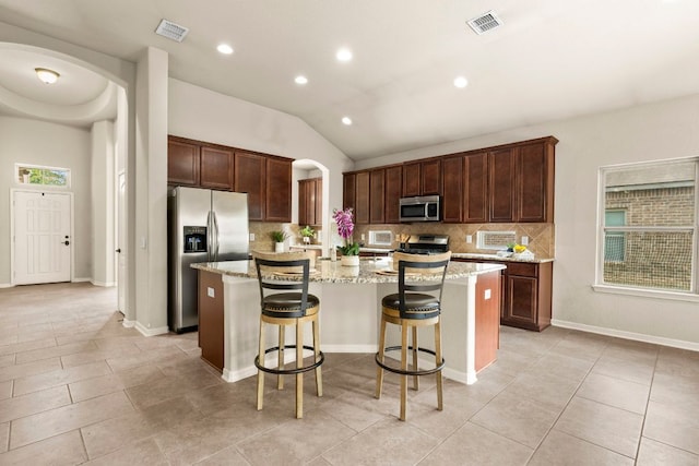 kitchen with visible vents, stainless steel appliances, and arched walkways