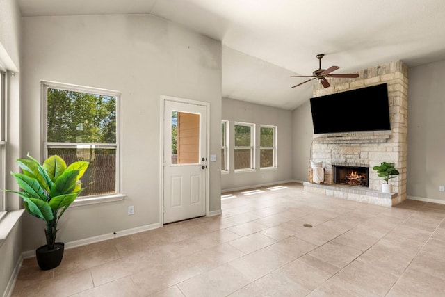 unfurnished living room featuring lofted ceiling, light tile patterned flooring, ceiling fan, and a fireplace