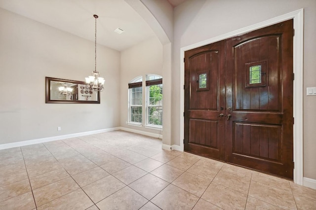605 River Oaks Dr, Austin, TX 78748 - entryway featuring arched walkways, baseboards, a chandelier, and light tile patterned flooring