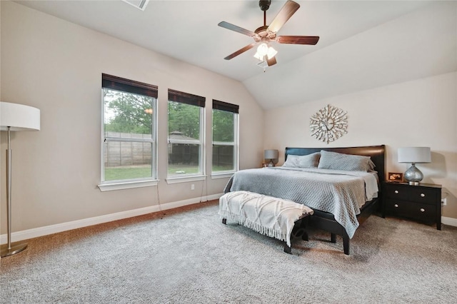 carpeted bedroom with ceiling fan, lofted ceiling, and baseboards