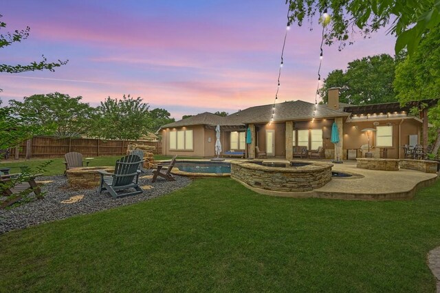605 River Oaks Dr, Austin, TX 78748 - rear view of house with an outdoor fire pit, a yard, a patio, and a chimney