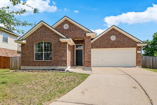 11805 Larch Valley Dr, Austin, TX 78754 - view of front facade featuring brick siding, concrete driveway, and a garage