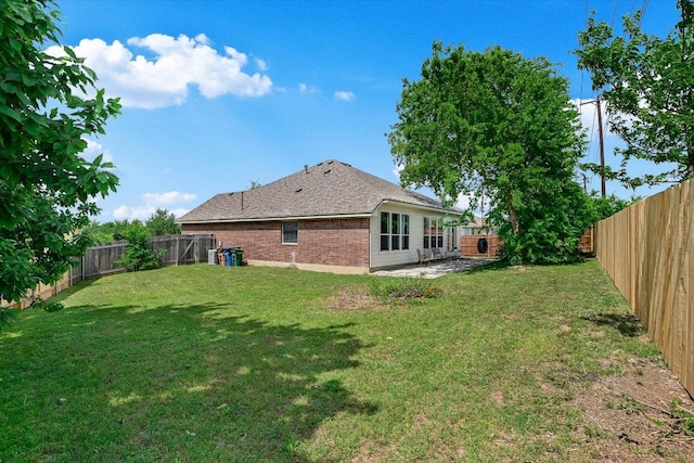11805 Larch Valley Dr, Austin, TX 78754 - back of property with a fenced backyard, a patio area, and brick siding