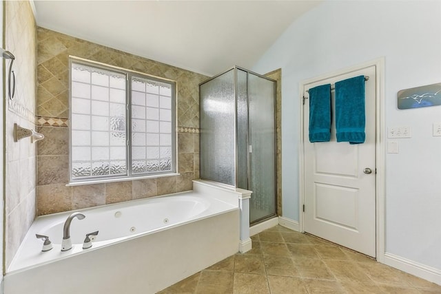 bathroom featuring baseboards, a stall shower, and a jetted tub