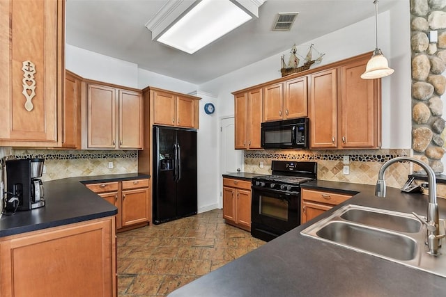 kitchen with visible vents, black appliances, dark countertops, and a sink