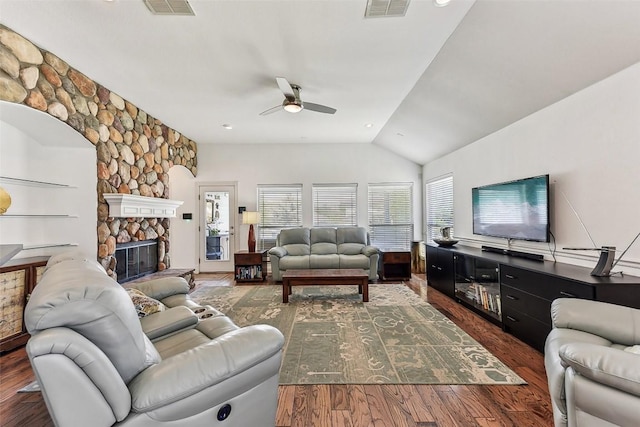 living area featuring a fireplace, ceiling fan, lofted ceiling, visible vents, and wood finished floors