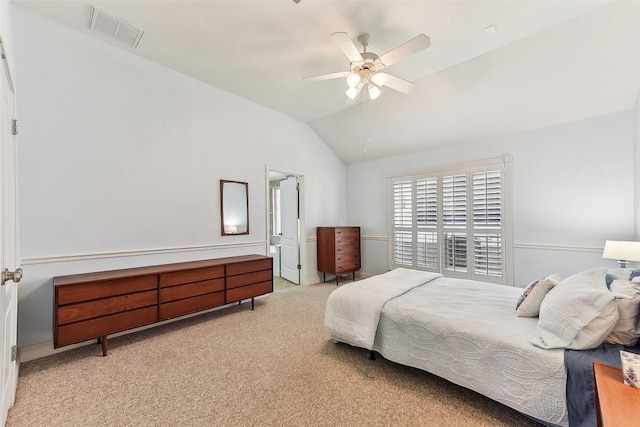 bedroom featuring lofted ceiling, light colored carpet, visible vents, and ceiling fan