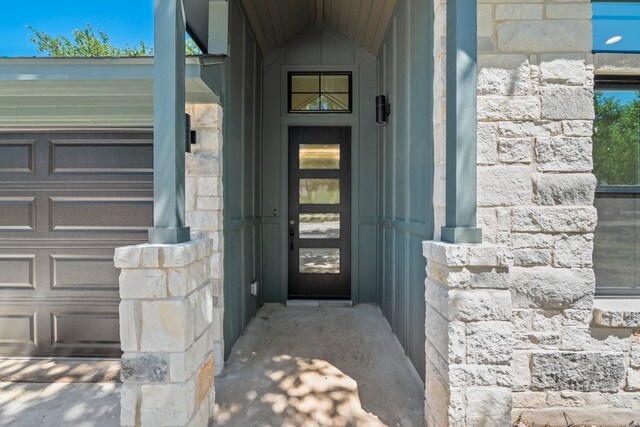 doorway to property featuring stone siding