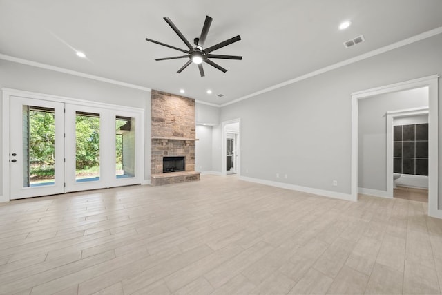 unfurnished living room with visible vents, a stone fireplace, light wood-type flooring, a ceiling fan, and crown molding