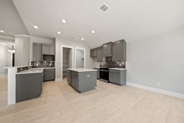 kitchen with visible vents, gray cabinets, tasteful backsplash, and vaulted ceiling