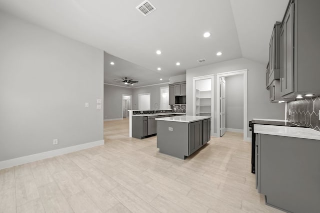 kitchen featuring recessed lighting, ceiling fan, a center island, visible vents, and light countertops
