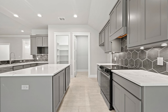 kitchen featuring gray cabinetry, recessed lighting, a sink, and black electric range oven