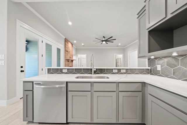 kitchen featuring gray cabinetry, ceiling fan, dishwasher, and a sink
