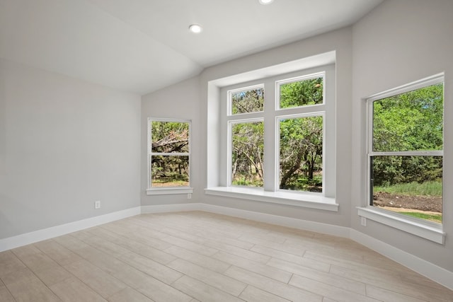 additional living space featuring baseboards, recessed lighting, light wood-style floors, and vaulted ceiling