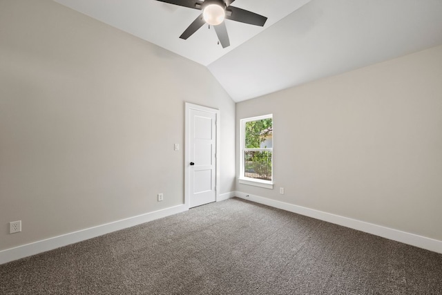spare room featuring lofted ceiling, ceiling fan, carpet flooring, and baseboards