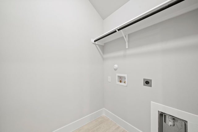 laundry area with laundry area, electric dryer hookup, hookup for a gas dryer, washer hookup, and baseboards