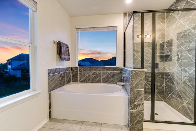 full bath featuring a shower stall, a garden tub, and tile patterned flooring