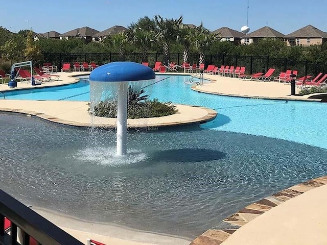 pool with fence and a patio area