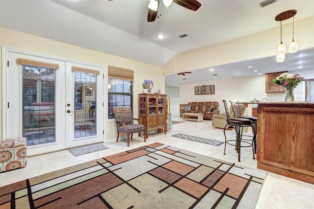 living room with bar area, ceiling fan, visible vents, french doors, and lofted ceiling